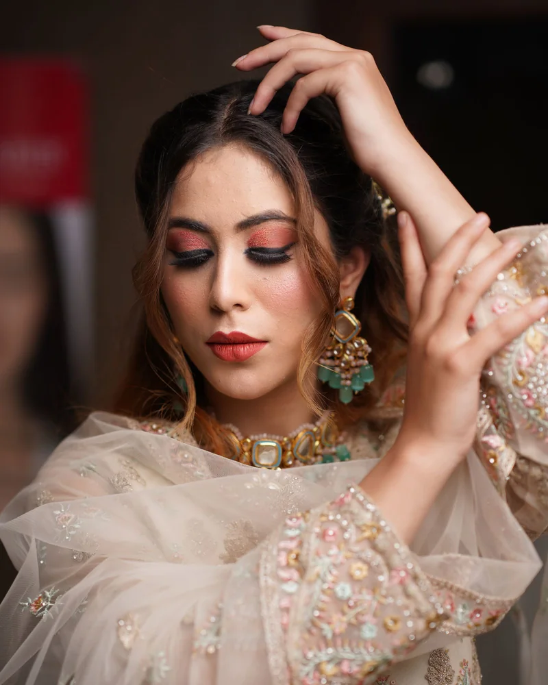 South Asian bride in softly coloured attire and traditional jewellery