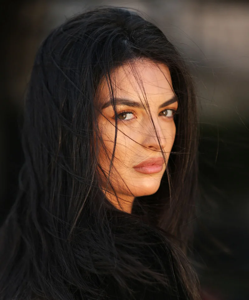 Dark hair moving softly around a woman’s face