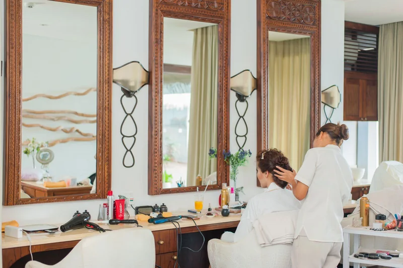 Photographed salon with timber-framed mirrors, natural light and warm materials